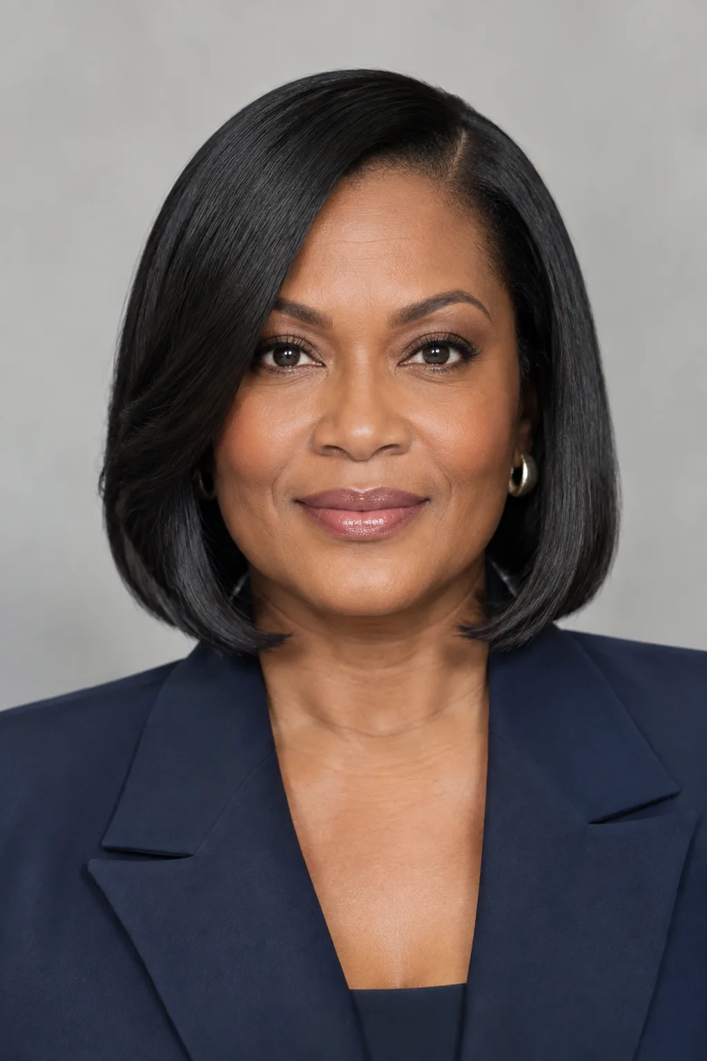 Black woman with a sleek straightened bob and rounded ends in a studio